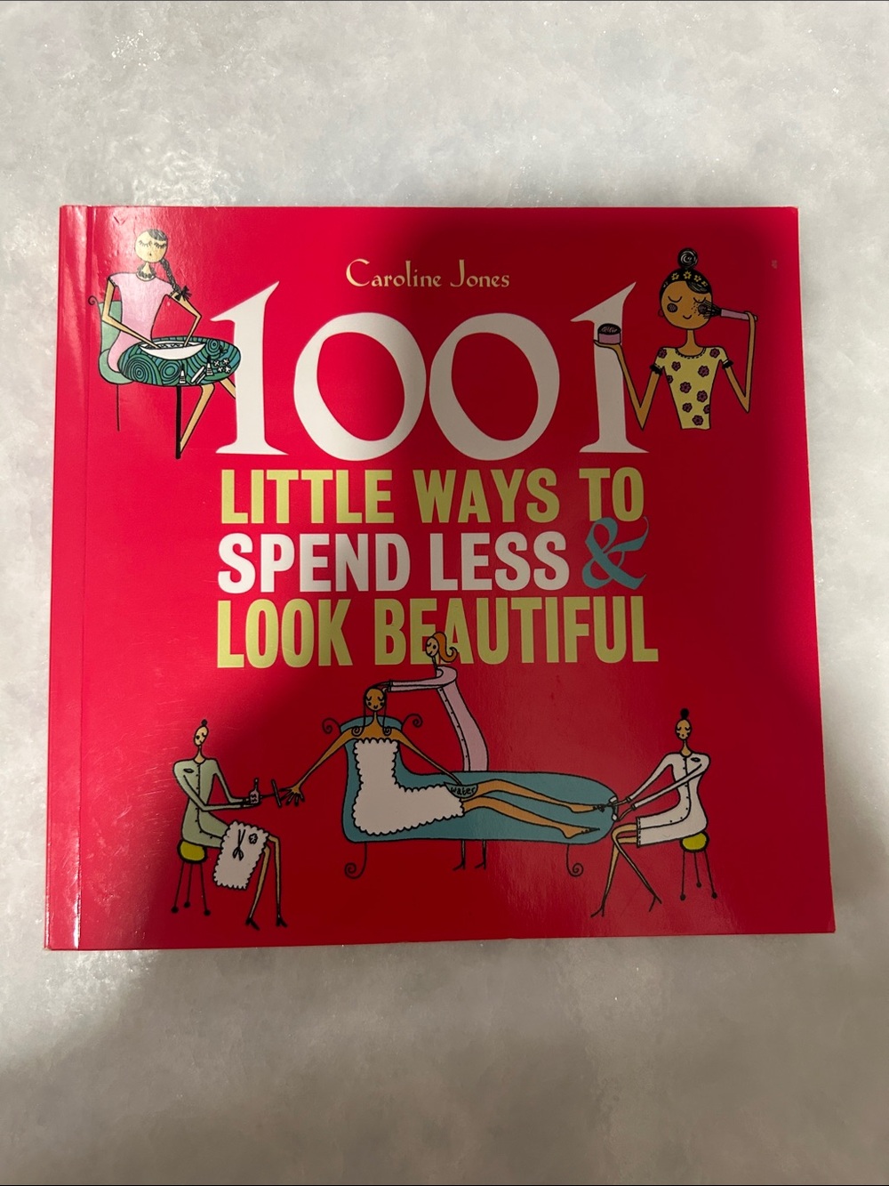 1001 Little Ways to Spend Less & Look Beautiful - Red paperback book